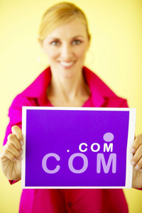 lady holding dot com sign